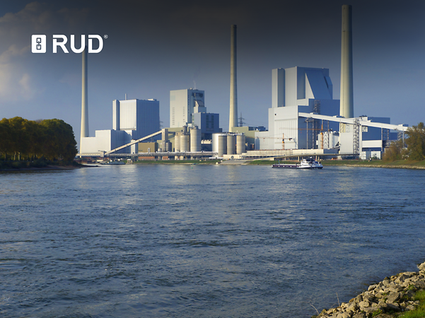 Logo of RUD in front of a power plant on the river