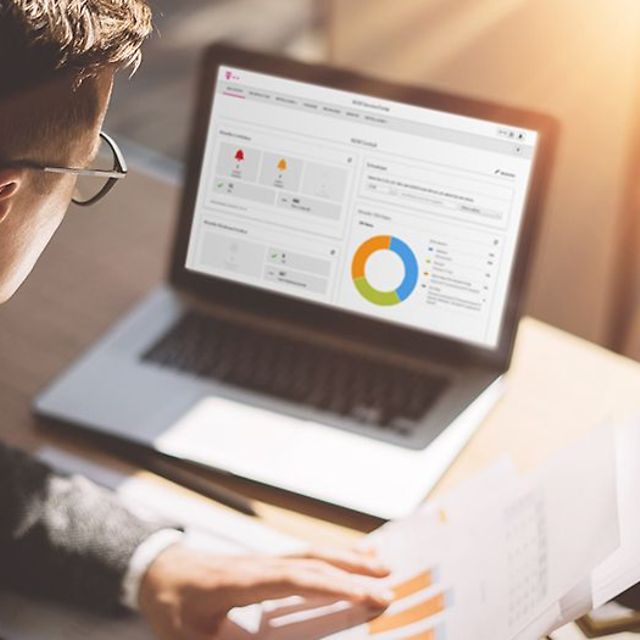 A person views a data analysis with charts for the IoT M2M Service Portal on a laptop.