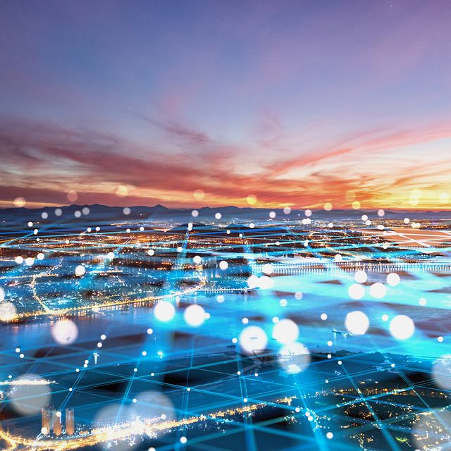 Stage backdrop for IoT use cases with a city and sunset background and an abstract network overlay.