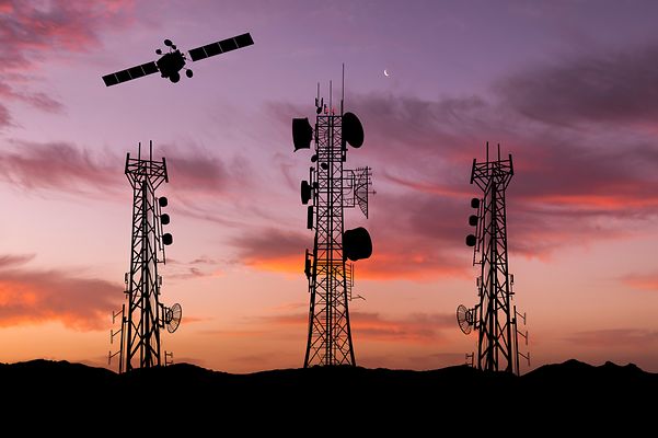 Transmission masts and satellites before sunset symbolize uninterrupted reception worldwide.