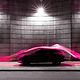 Modern car illuminated by magenta light trails symbolizing digital connectivity.